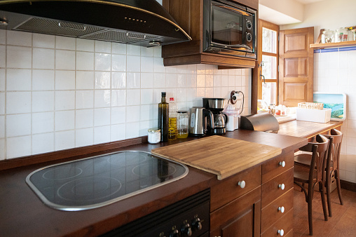 Domestic kitchen wit rustic style and wooden furniture