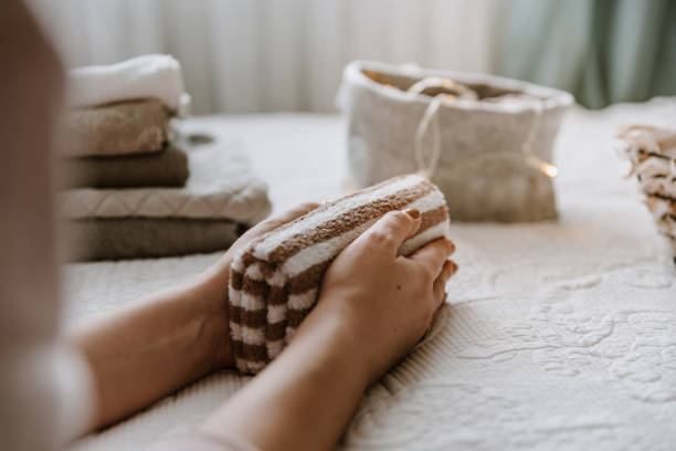 istock Woman folding clothes in bedroom, organizing laundry in boxes and baskets. 1288079855