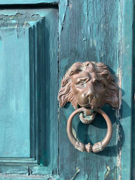istock Ancient lion-shaped door knocker - blue door 1288081976