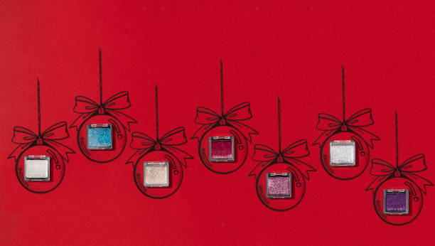 Christmas balls with beauty products on red background