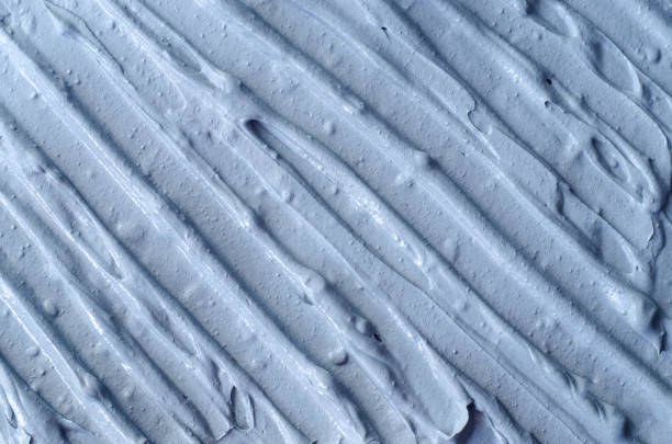 istock Light blue facial clay (mask, face cream, body wrap) texture close up, selective focus. Abstract background with brush strokes. 1288082885