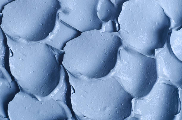 istock Light blue facial clay (mask, face cream, body wrap) texture close up, selective focus. Abstract background with brush strokes. 1288083031
