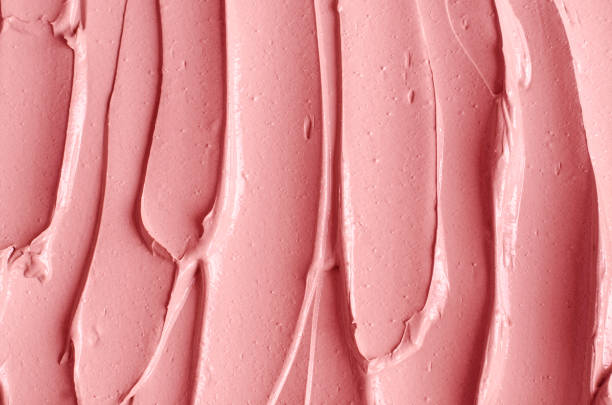 istock Pale pink cosmetic clay (alginate facial mask, face cream, body wrap) texture close up, selective focus. Abstract background with brush strokes. 1288083062