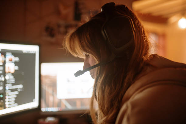 istock Young woman playing video games 1288083313