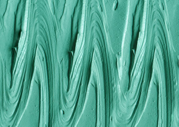 istock Green cosmetic clay (kelp facial mask, face cream, spirulina body wrap) texture close up, selective focus. Abstract background with brush strokes. 1288083438