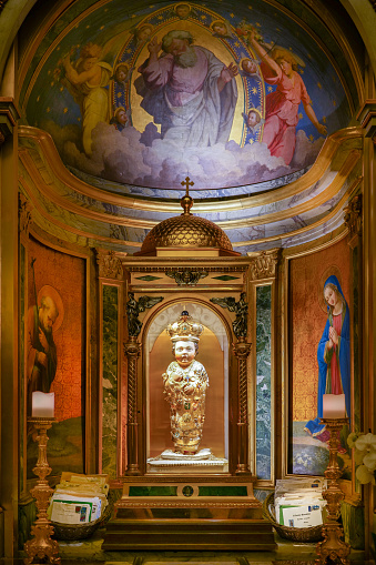 An image of the Holy Baby Jesus, a wooden sculpture carved in the XV century with olive wood from the Garden of Gethsemane in Jerusalem and covered with precious ex voto, present in a chapel of the ancient church of Santa Maria in Aracoeli, in the Capitoline Hill. According to popular belief, this figure is endowed with miraculous powers. Photo in high definition format.