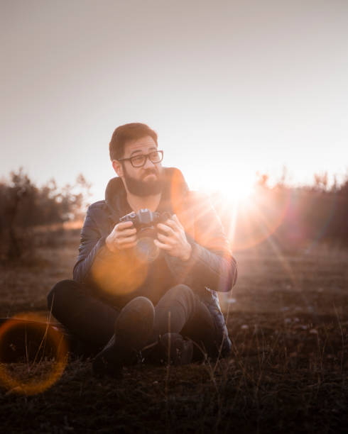 istock young man checking photo from the camera Stock Photo 1288085302