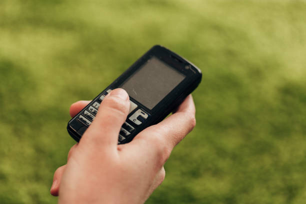 istock Girl Holds An Old Button Phone In Her Hand 1288088761