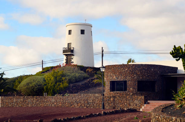 Yaiza, Spain - January 16, 2012: Old windmill converted in a home on the Canary Island of Lanzarote