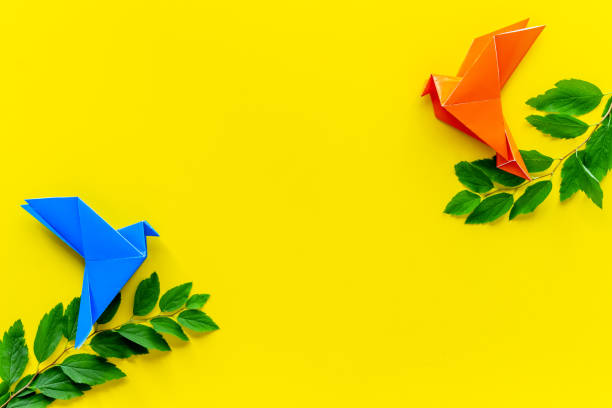 istock Colored origami - paper birds with leaves, overhead view 1288090028