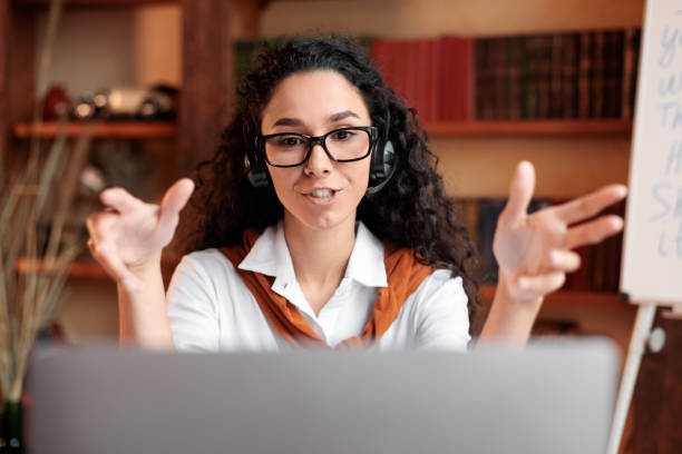 istock Woman sitting at desk, having video call on computer 1288091108