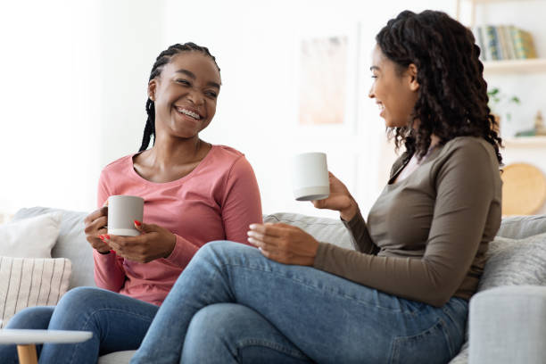 istock Two pretty black ladies drinking tea at home 1288091595