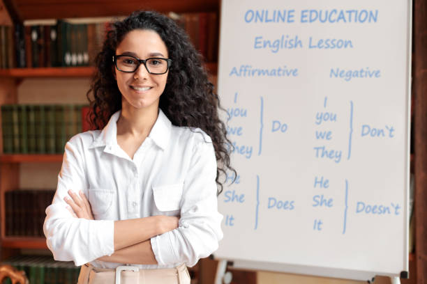istock English teacher standing at board, posing at camera 1288092713