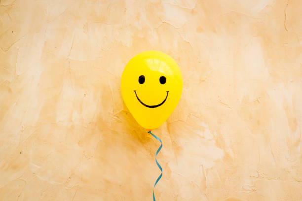 istock Happiness emotion face on balloon - joy mood background. Top view, copy space 1288092819