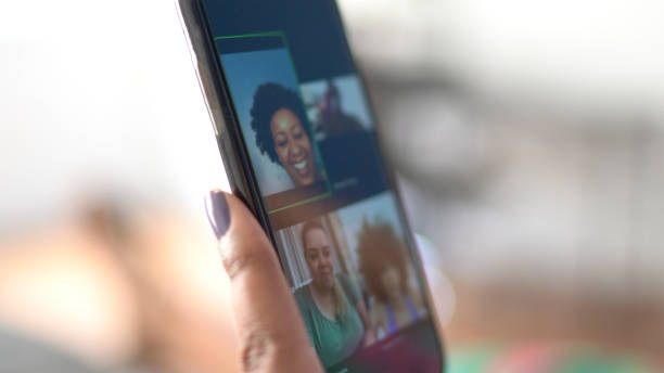 istock Mobile screen of friends video chat at home 1288094083