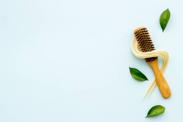 istock Female blond hair wirh bamboo brush, flat lay 1288096881