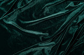 Tidewater green color velvet  fabric background. Close up of green textured background.