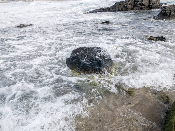 istock Beach on the sea with waves and stones in water 1288098242