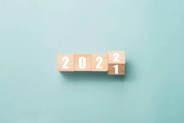 Merry Christmas and happy new year concept, Flipping of wooden cube block change from 2021 to 2022.