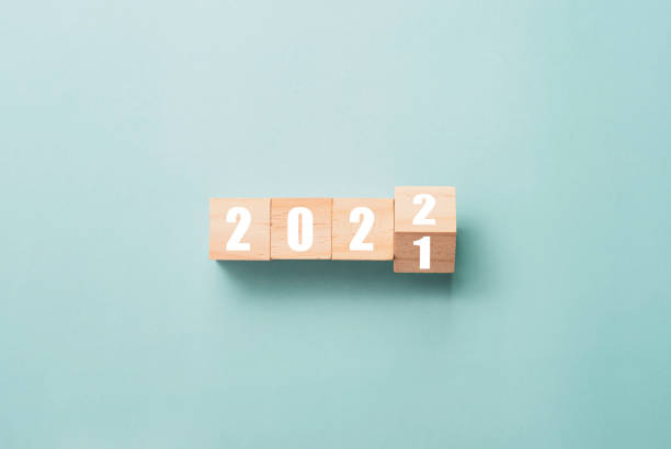 wesołych świąt i szczęśliwego nowego roku koncepcji, przerzucanie drewnianych kostki bloku zmiany od 2021 do 2022. - year block cube new years eve zdjęcia i obrazy z banku zdjęć