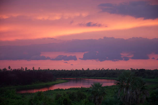 Pink and orange sky reflecting in the Paraguay River in the North of Paraguay, near Bolivian and Brazilian border. Pantanal region.