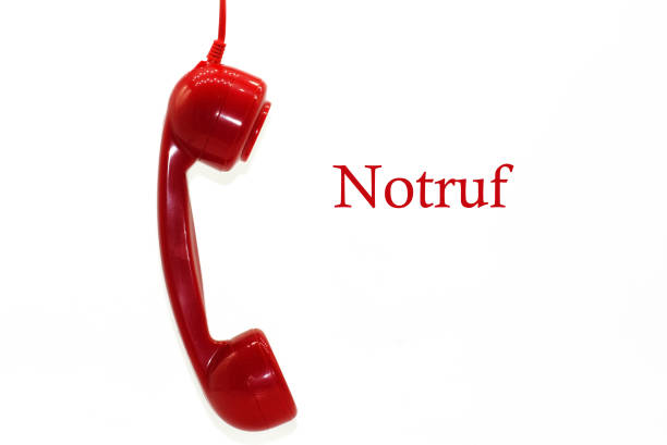 Red phone with lettering emergency call on white background