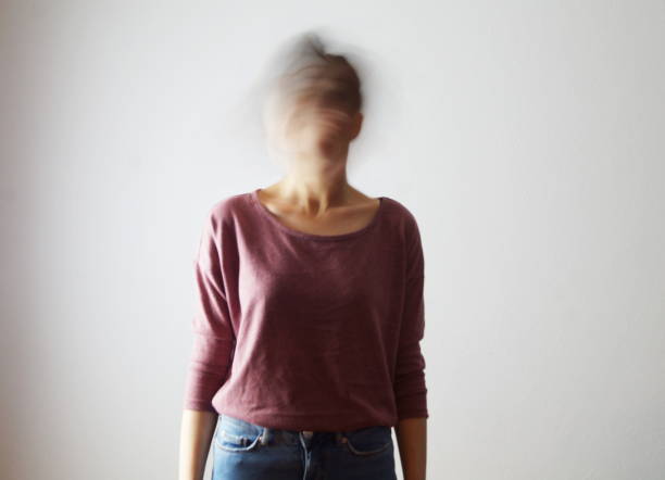cofused woman with blurred face - fading imagens e fotografias de stock
