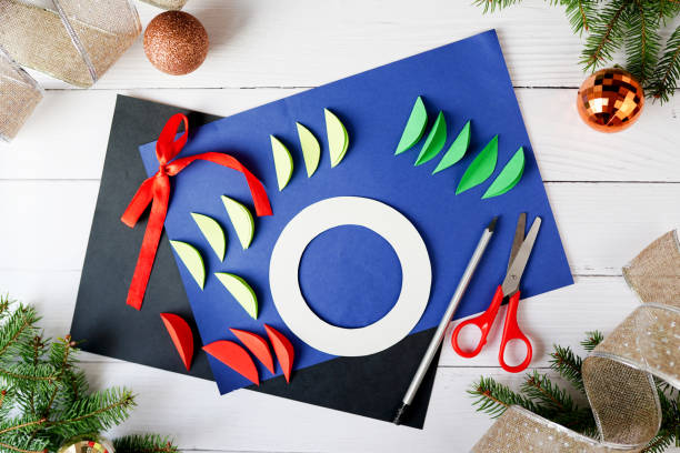 istock How to make christmas wreath from paper. Step by step instructions. Handmade DIY new year holiday decoration project. Step 2 1288103130
