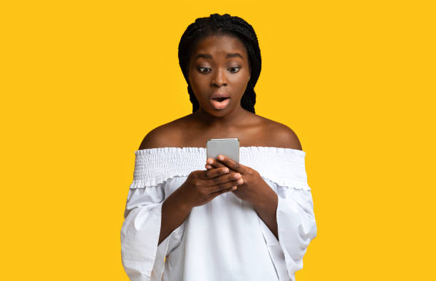 istock Omg. Surprised Black Woman Looking At Smartphone Screen With Shocked Face Expression 1288103331