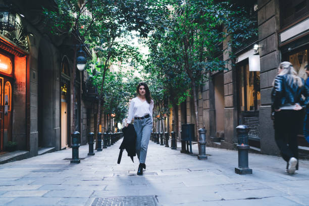 istock Serious woman walking on pavement 1288103909