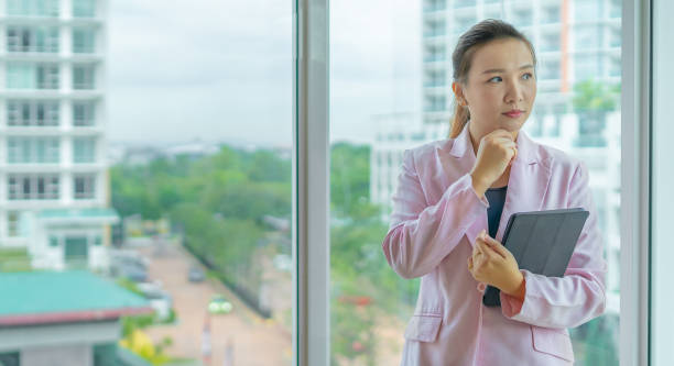 istock Serious Asian Businesswoman Thinking at Office 1288105868