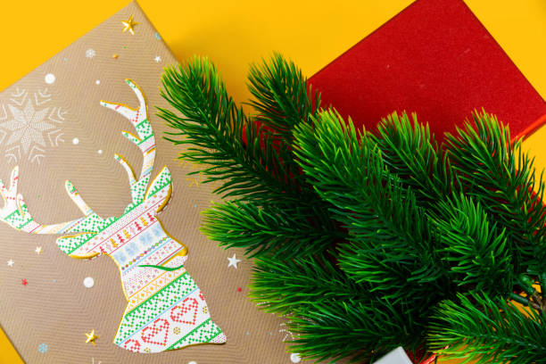 istock Christmas composition, gifts, beautiful decorations, fir branches, yellow background, layout, template, top view 1288108213