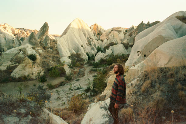 istock Man standing and looking at caves in  Cappadocia in Turkey 1288108529