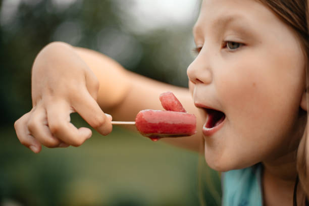 istock Child eating ice cream outdoors. 1288111847