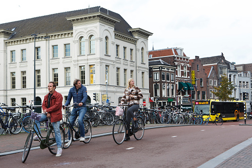 Utrecht, Netherlands October 19, 10, 2019: Cyclists waiting on their bicycles on the street in Utrecht, the Netherlands