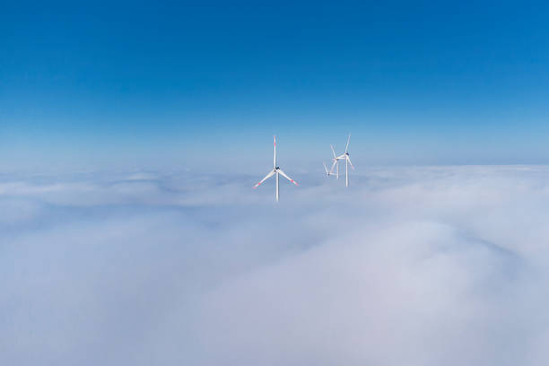 Wind turbines over the fog - aerial view