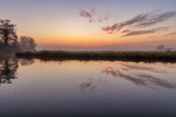 istock Colorful sunrise in Dutch polder landscape 1288114597