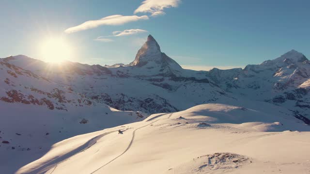 Matterhorn Mountain at Sunset in Winter. Swiss Alps. Switzerland. Aerial View. Reveal Shot. Drone Flies Forward, Camera Tilts Up