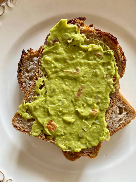 istock Mash Avocado dip or Mashed Guacamole Puree with Toast Bread for Breakfast in Plate. 1288116127