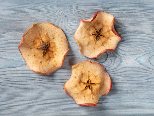 istock Top view of tree apple chips on a white wooden background 1288117161