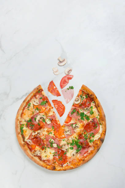 istock meat Pizza with vegetables on white marble background with ingredients 1288118312