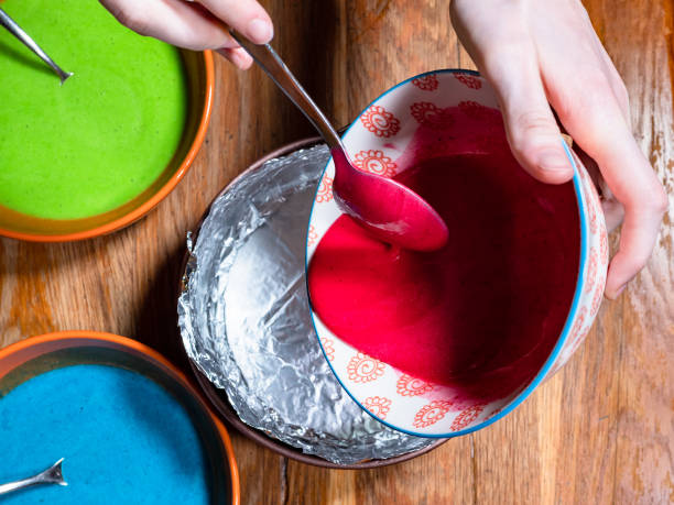 istock pouring of red colored liquid dough in pan 1288118809