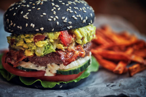istock Mexican Black Burger Buns with Beef Pattie, Guacamole, Tomato and Lettuce 1288120247