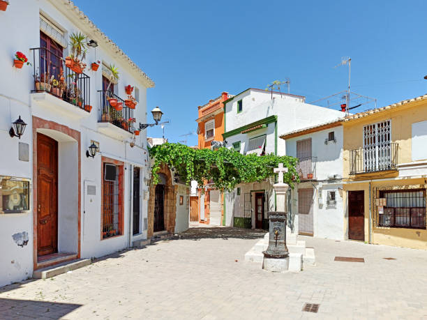 Denia. Spain Pretty charming houses decorated with flowerpots ivy leaves in empty small square of Denia old town, spanish historical coastal city in province of Alicante Costa Blanca. Espana. Spain spanish flower pots stock pictures, royalty-free photos & images