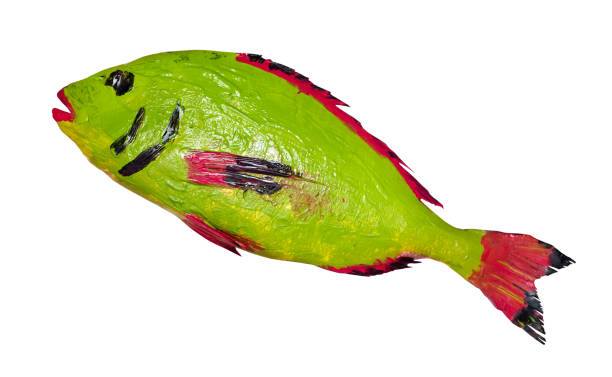 istock green, red and black painted fish cut out on white 1288122682