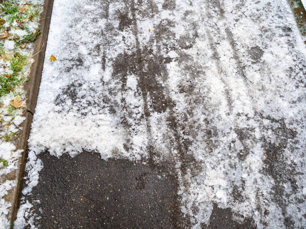 istock asphalt path partially cleared of ice in city park 1288124192