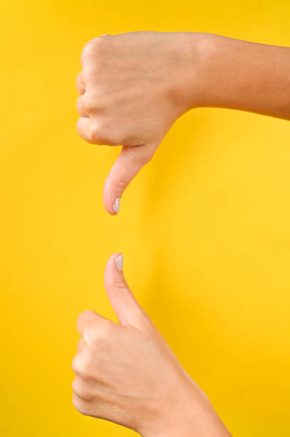 istock Thumb up on yellow background 1288125323