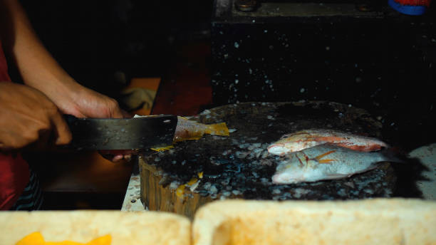 istock cutting fish with a knife into the Indonesian fish 1288125975