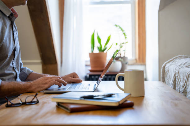 istock Man working from home at a table in is home office. 1288126031