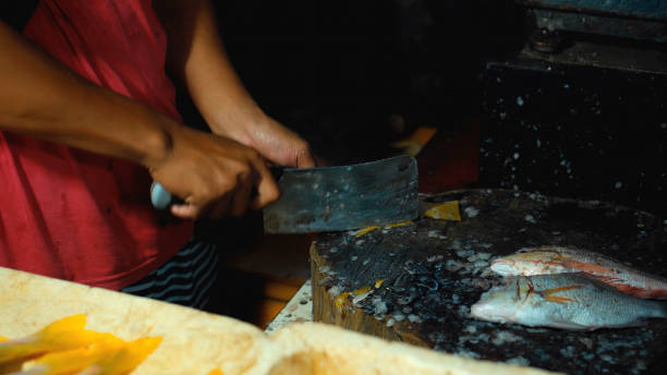 istock cutting fish with a knife into the Indonesian fish 1288126076